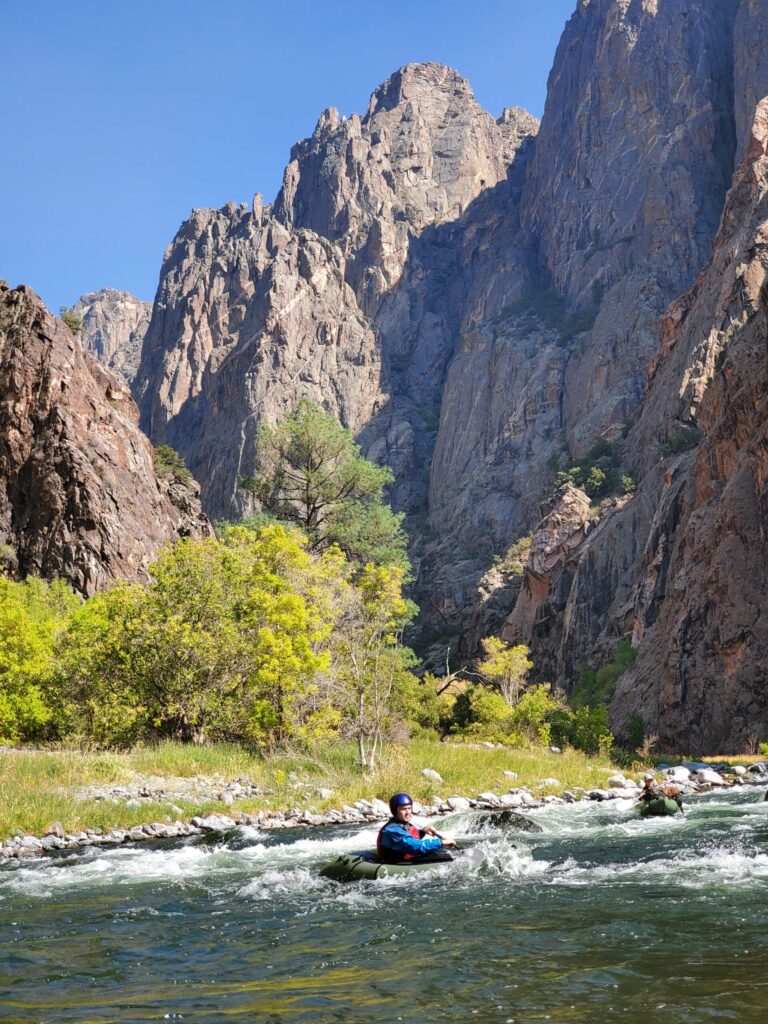 Pack rafting through a river